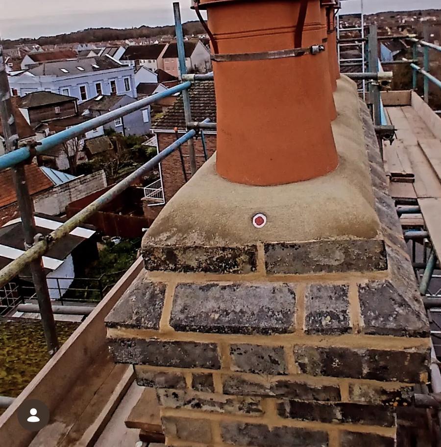 Rebuilt chimney with new flaunching and pot on scaffold